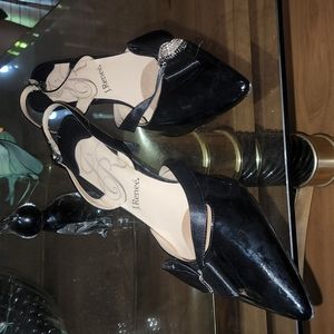 This pair of gorgeous slings are black patent leather.